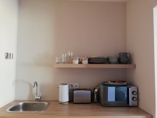 eca-agora-guest-house-vila-do-conde-the-mandarim-room-king-sized-bed-bathroom-with-meating-area-slider-7